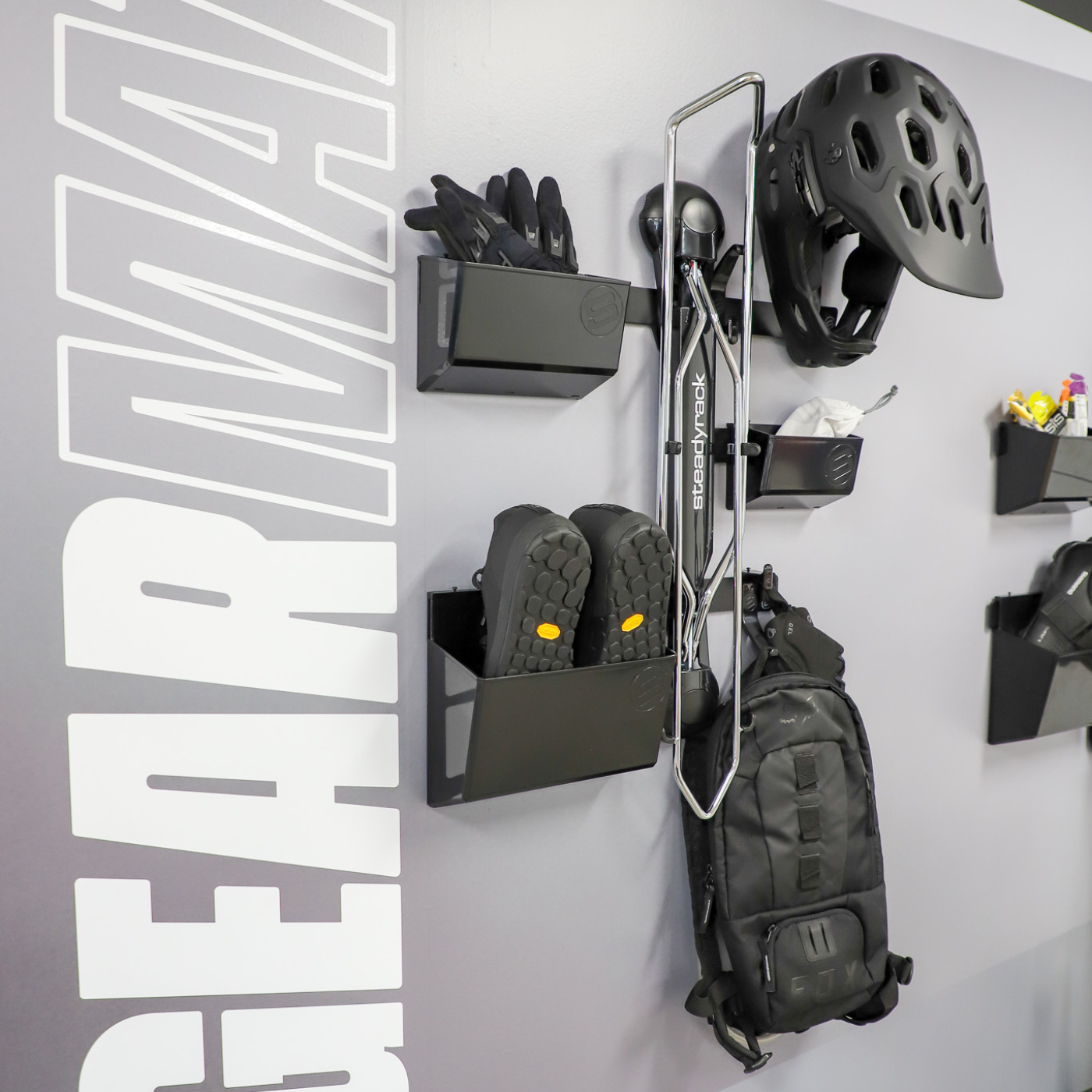 Wall-mounted storage system with a Steadyrack bike rack installed on a wall with accessories stored
